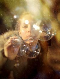 Portrait of woman holding bubbles