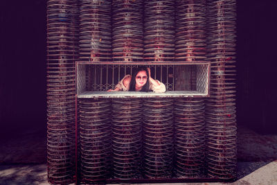 Portrait of woman in metal structure