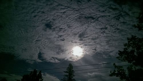 Low angle view of power lines against sky