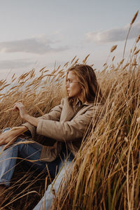 Woman in field against sky