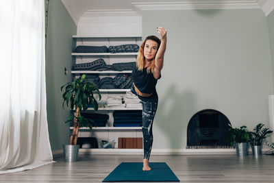 Yogic woman practicing in yoga studio