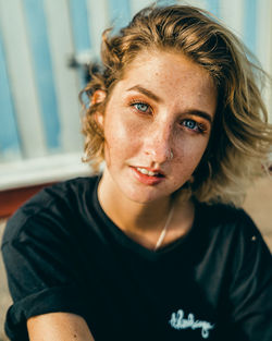 Portrait of young woman sitting at home