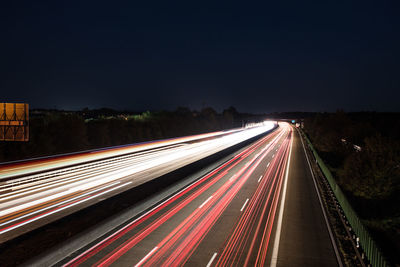 High angle view of light trails on highway at night