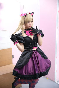 Full length of woman standing against pink wall