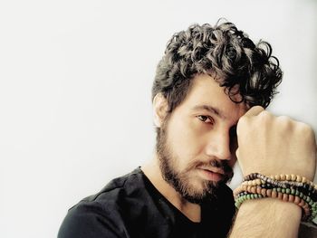 Close-up portrait of young man against wall