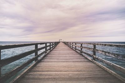 Pier over sea against sky
