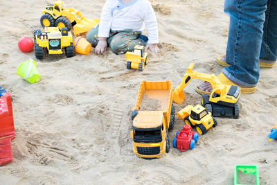 Low section of kid playing in sand