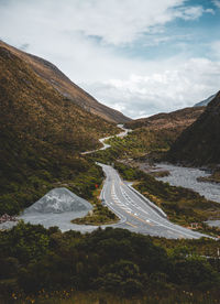 High angle view of road amidst mountains against sky