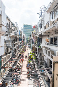 High angle view of vehicles on street amidst buildings in city