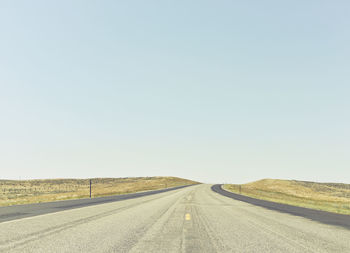 Road amidst landscape against clear sky