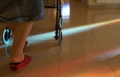 Low section of woman standing on tiled floor