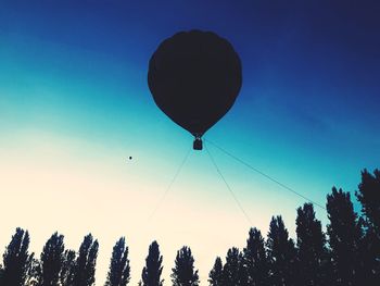 Low angle view of hot air balloon against clear blue sky