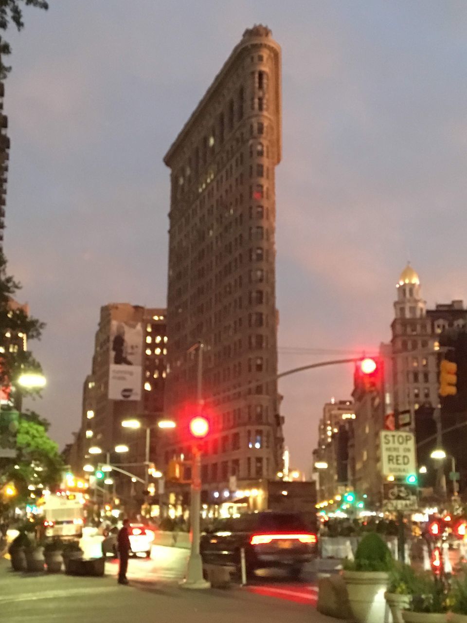 CITY STREET AND MODERN BUILDINGS AGAINST SKY DURING SUNRISE