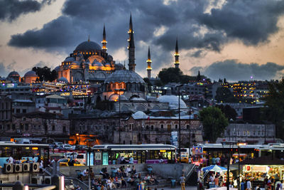 People at market against mosque in city