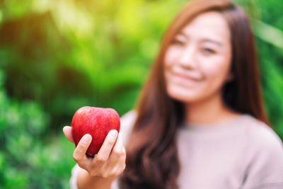 Portrait of woman holding apple