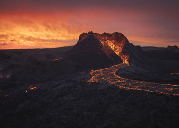 Picturesque view of active volcano with hot lava located against cloudy sunset sky in iceland