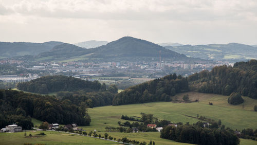 Scenic view of townscape and mountains against sky