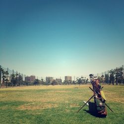 View of grassy field against clear sky