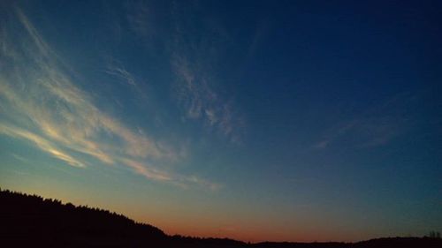 Silhouette of landscape against sky at sunset