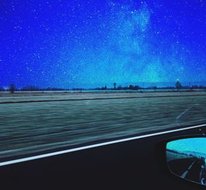 Scenic view of sea against clear blue sky at night