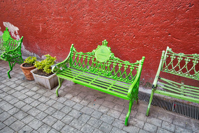 Empty bench against wall