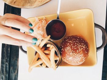 Close-up of hand and hamburger 