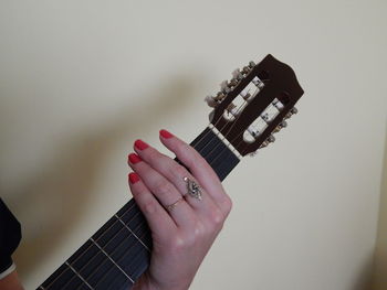 Cropped hand of woman playing guitar