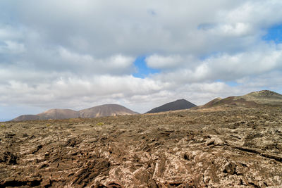 Scenic view of arid landscape against sky