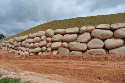 Rocks on field against sky