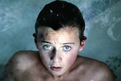 Close-up portrait of boy with snow