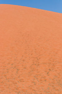 Sand dunes in desert against sky