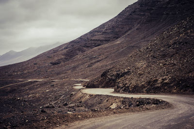 Scenic view of mountain road against sky