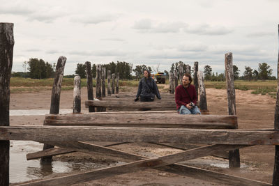 Couple sitting on a dock