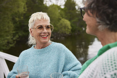 Smiling woman talking to friend