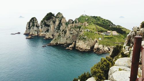 Panoramic view of rocks on sea against sky