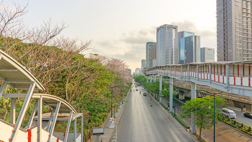 Road amidst buildings against sky in city