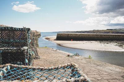 Scenic view of sea against sky harbour pier scotland beach seaside crates