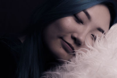 Close-up of woman sleeping on pillow