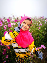 Portrait of cute girl with pink flowers