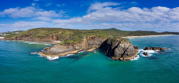 Panoramic view of sea and rocks against sky