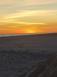 Scenic view of beach against sky during sunset