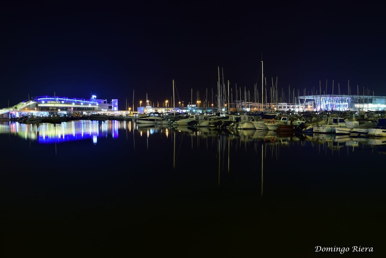 water, nautical vessel, moored, boat, reflection, illuminated, night, transportation, waterfront, mode of transport, harbor, clear sky, sea, copy space, sailboat, river, mast, lake, built structure, marina