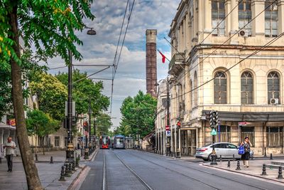 City street by buildings against sky