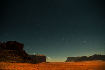 Scenic view of landscape against sky at night