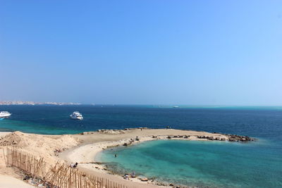 Scenic view of sea against clear blue sky