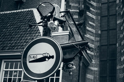 Low angle view of road sign against buildings in city