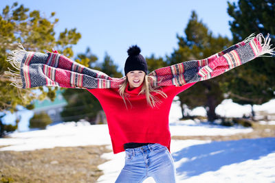 Low angle view of woman with arms raised