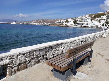 High angle view of empty bench by sea