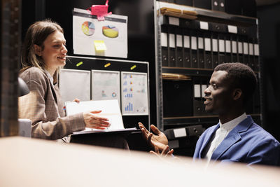 Side view of business colleagues working in office