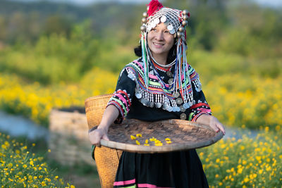 Woman smiling while standing on field